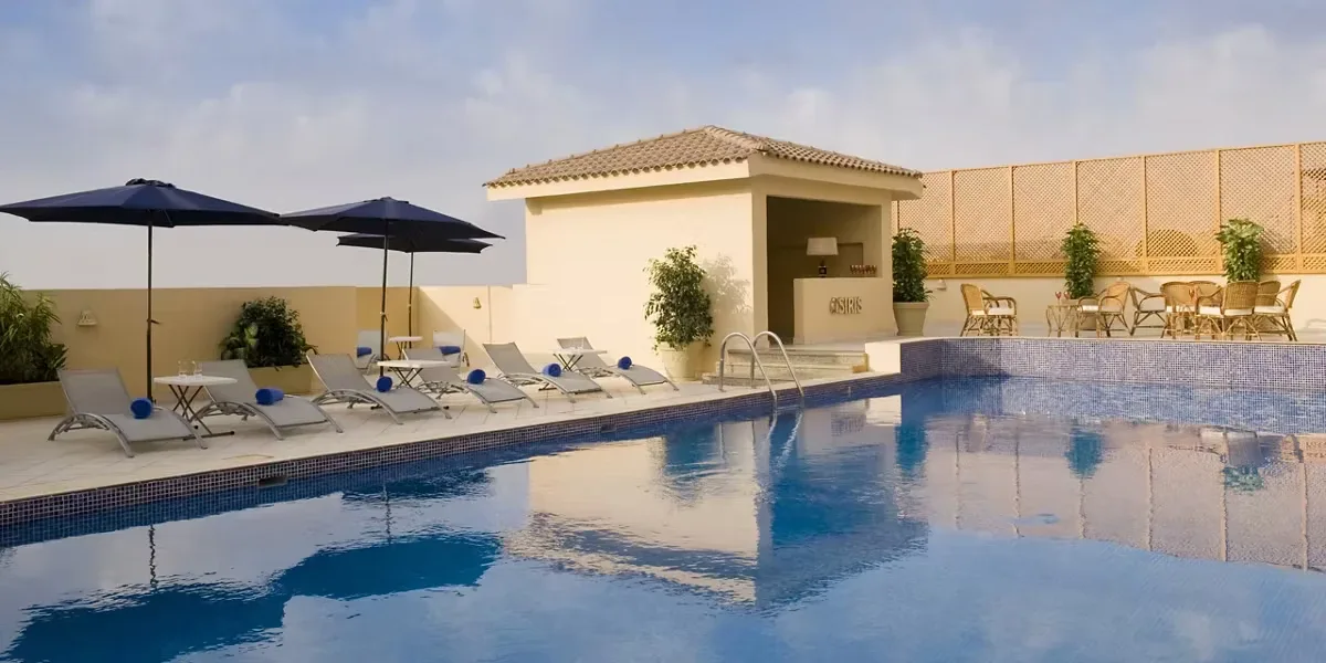 Rooftop pool and sun loungers at Barceló Cairo Pyramids