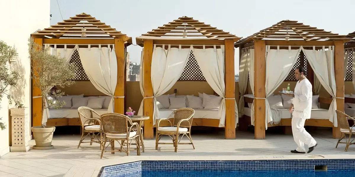 Shaded cabanas beside the rooftop pool