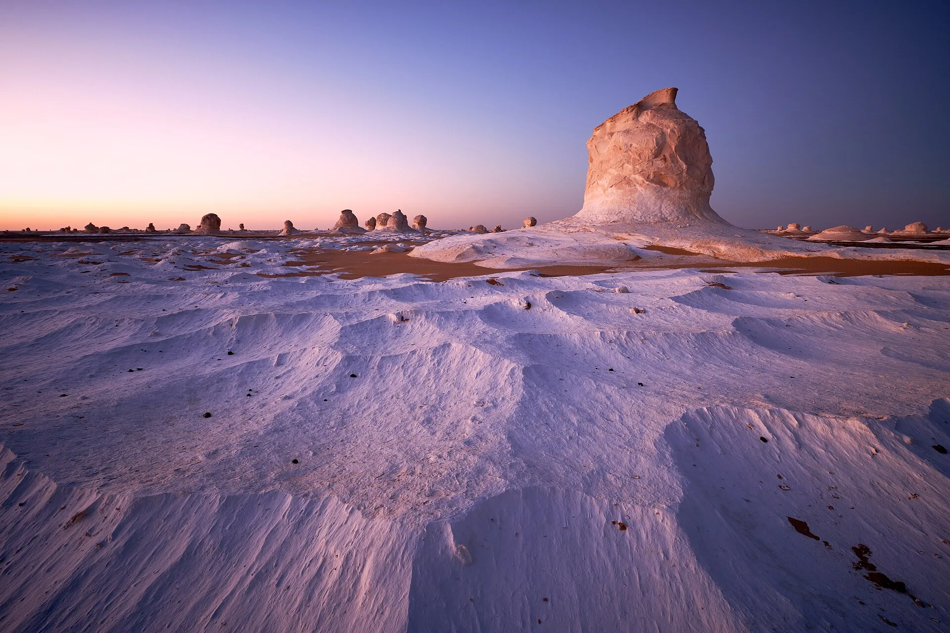 Chalk rock formation glowing at dusk in Egypt's White Desert National Park