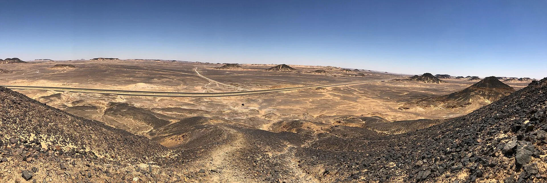 Panoramic view over the dark volcanic hills of Egypt's Black Desert