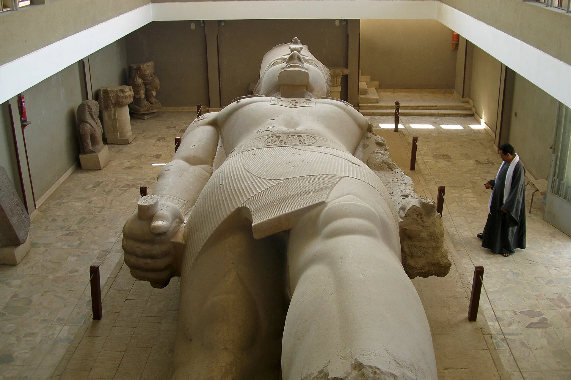 Colossal limestone statue of Ramesses II lying in the Memphis open-air museum