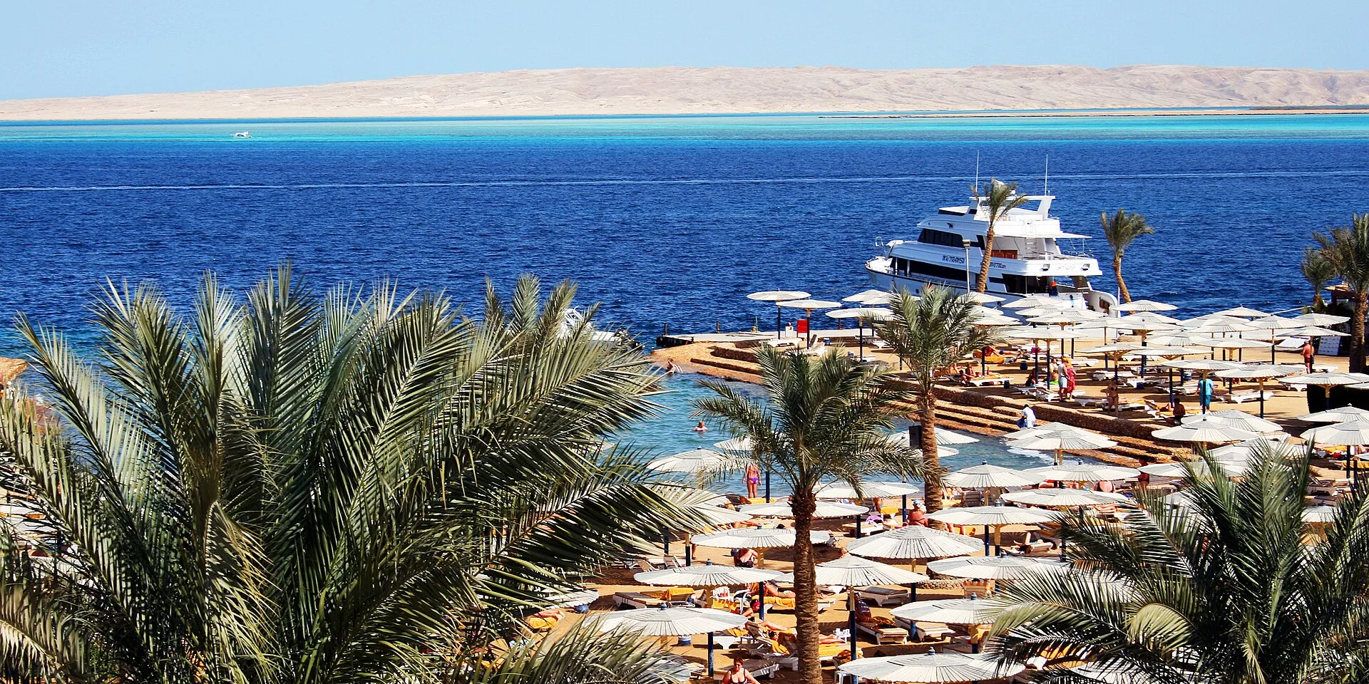 Palm-fringed hotel beach and small marina on the Red Sea at Hurghada