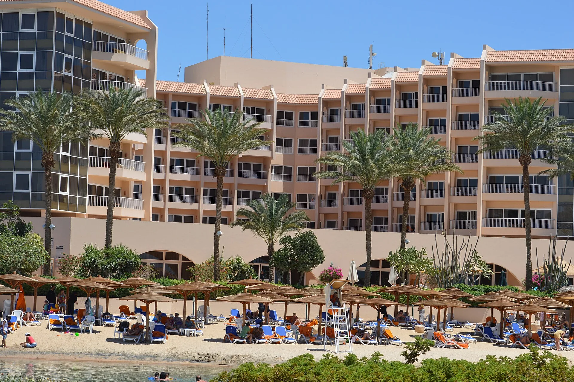 Beach, palms and guest wings of Hurghada Marriott Beach Resort