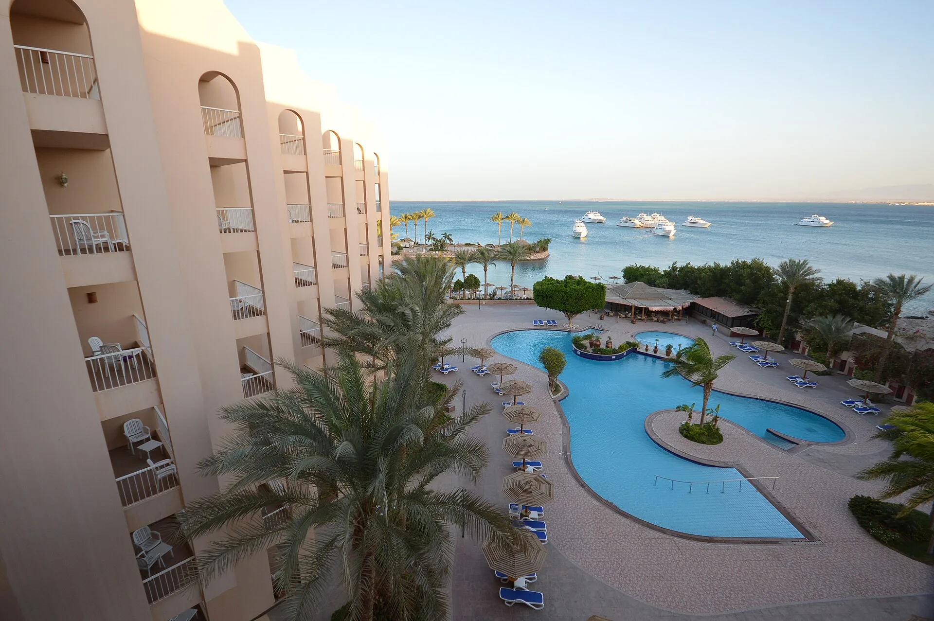 Free-form pool and the Red Sea seen from a balcony at Hurghada Marriott Beach Resort