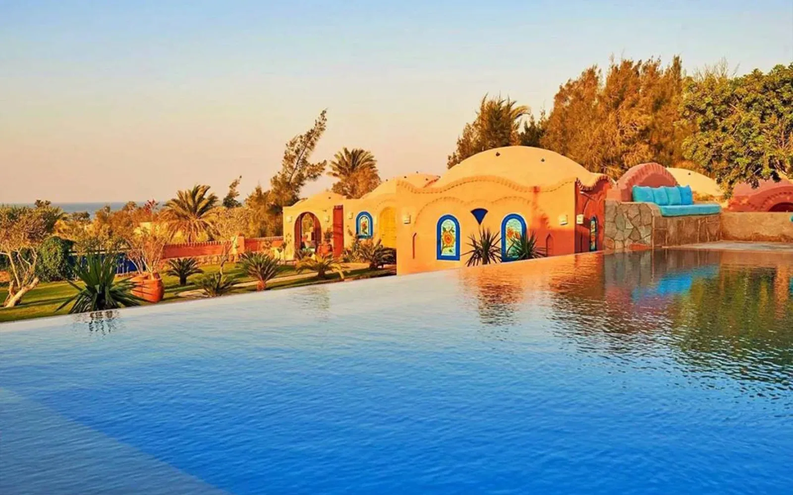 Infinity pool at Lazib Inn with domed Nubian-style buildings, Fayoum