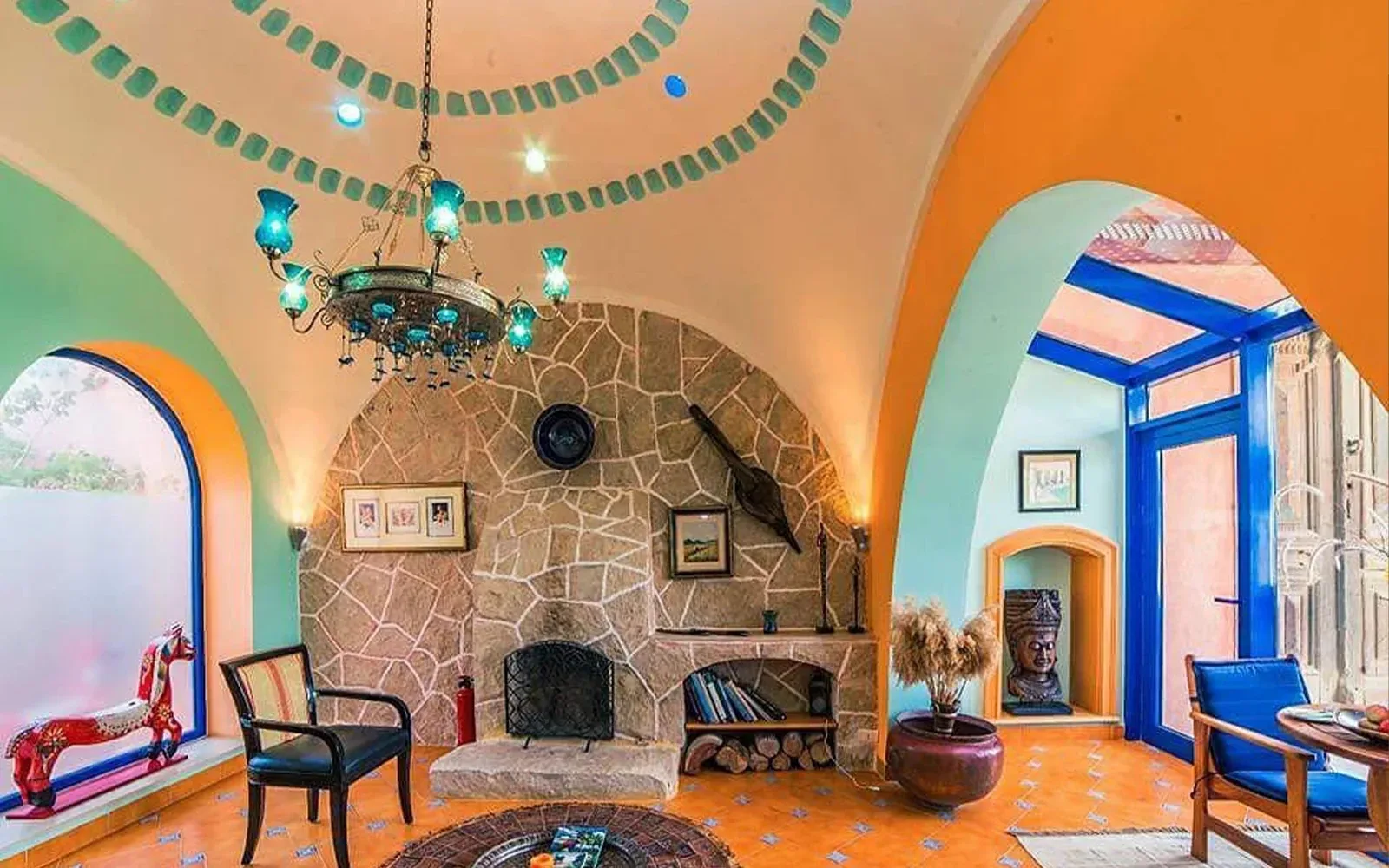 Lounge with fireplace under a painted dome, Lazib Inn