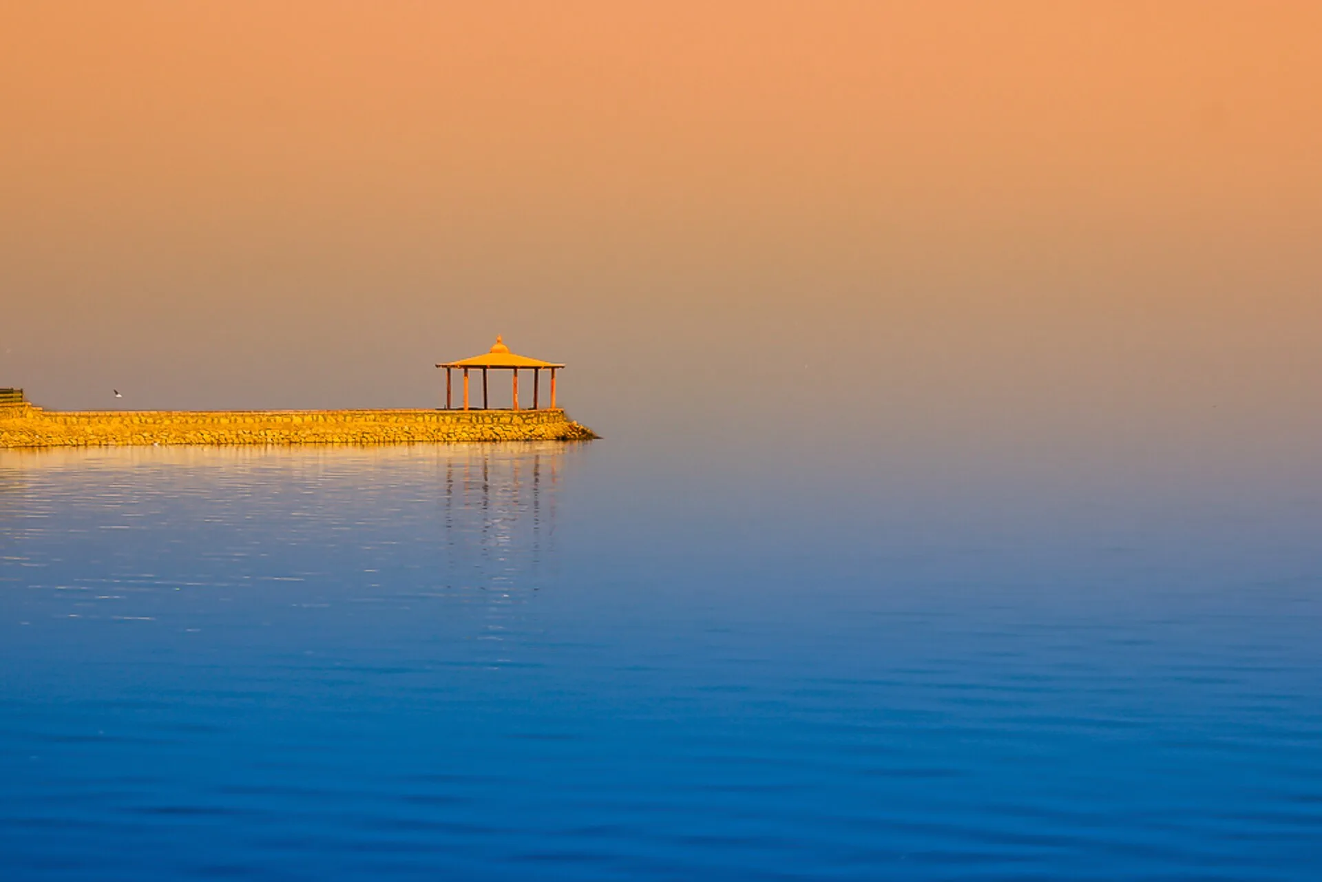 Golden sunset over the calm waters of Lake Qarun in Fayoum