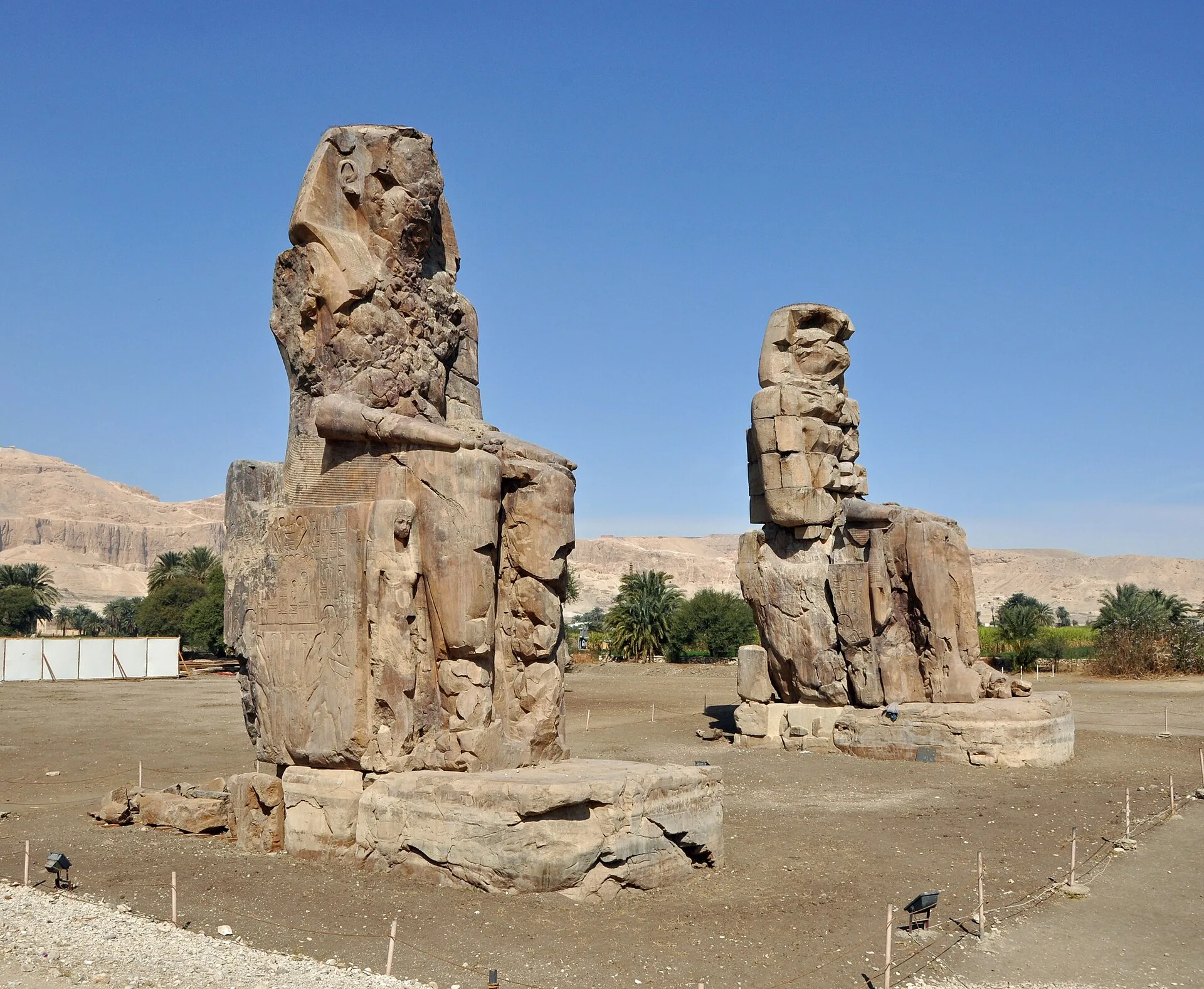 The weathered twin Colossi of Memnon on Luxor's west bank