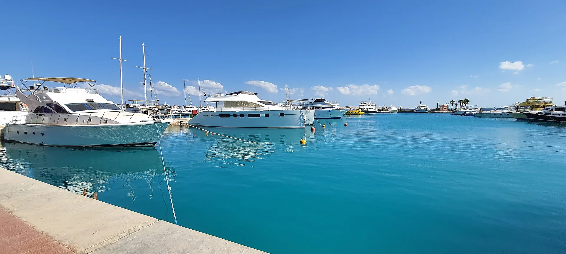 White yachts moored in the turquoise water of Hurghada Marina
