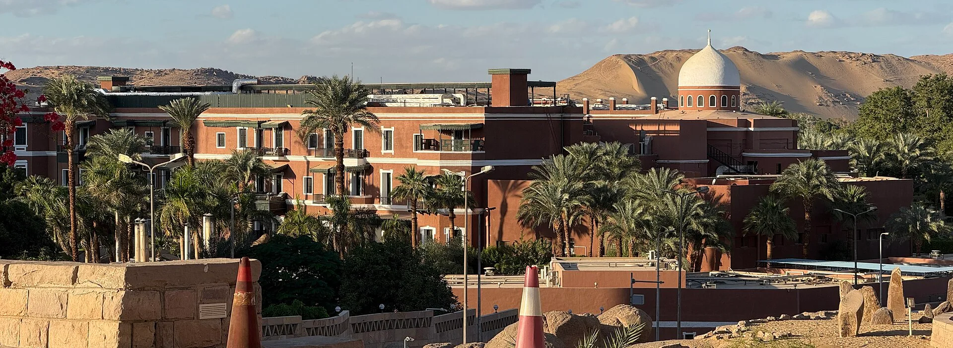 Palm gardens and domed rooftop of the Old Cataract hotel in Aswan