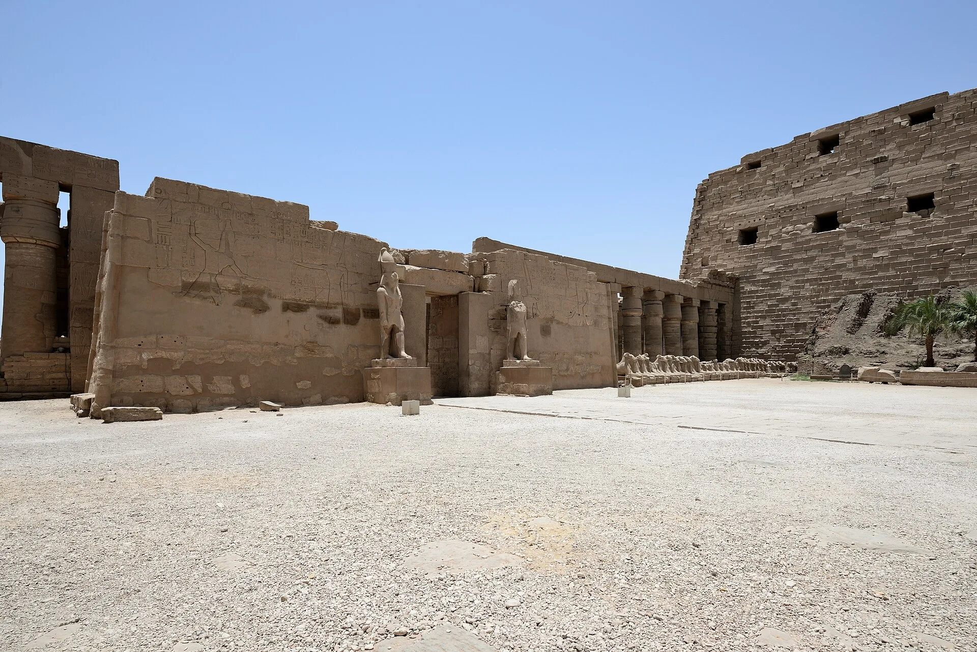 Ancient columns and statues within the Karnak Temple complex, Luxor
