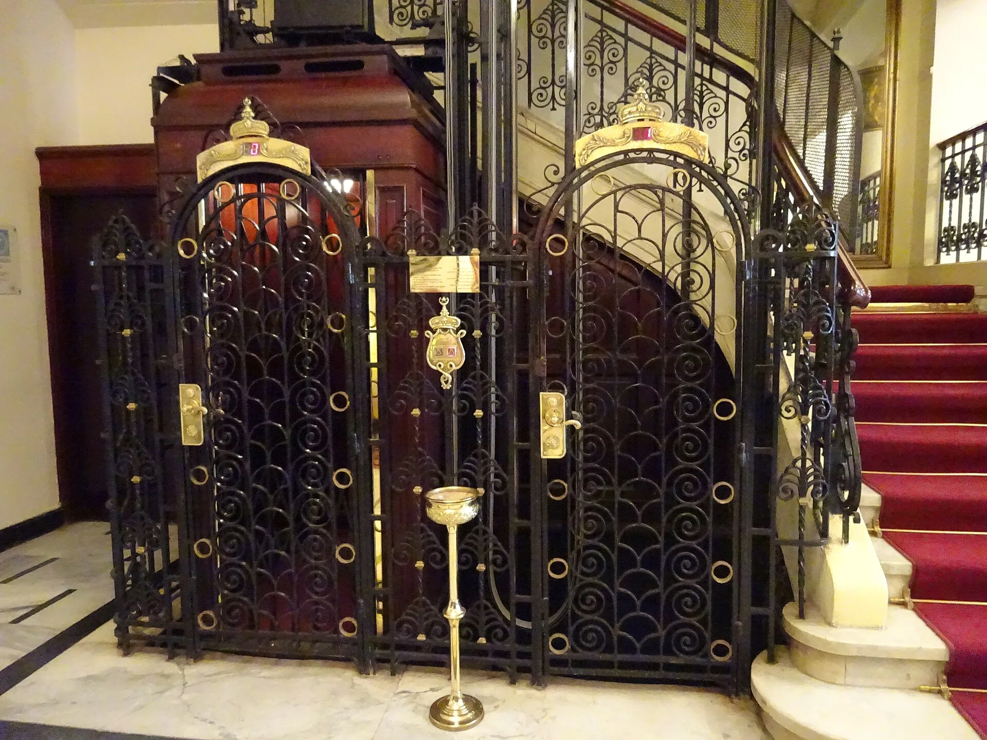 Historic wrought-iron cage lift inside the Cecil Hotel