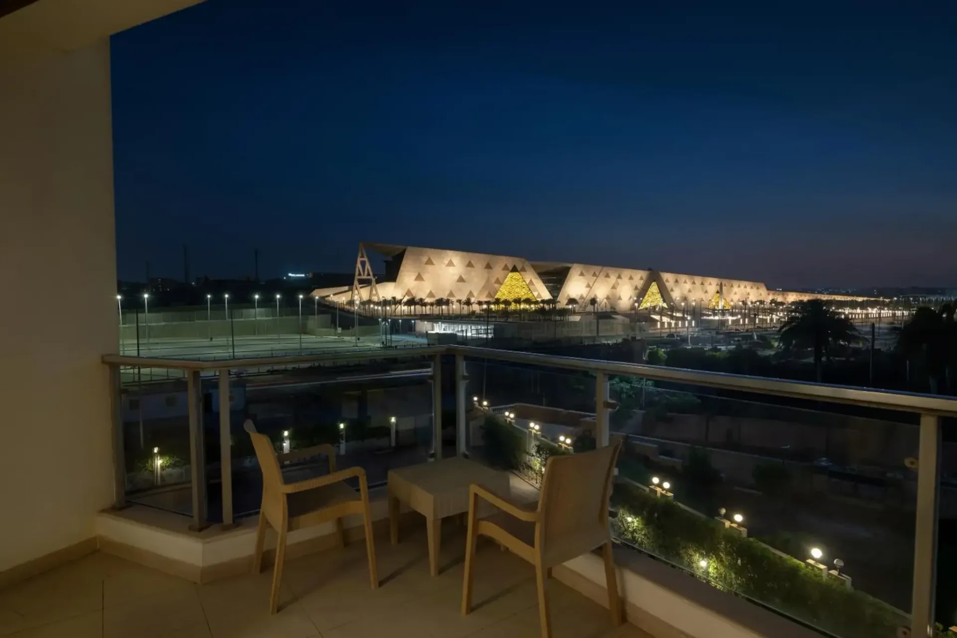 Night view towards the Grand Egyptian Museum from a hotel balcony